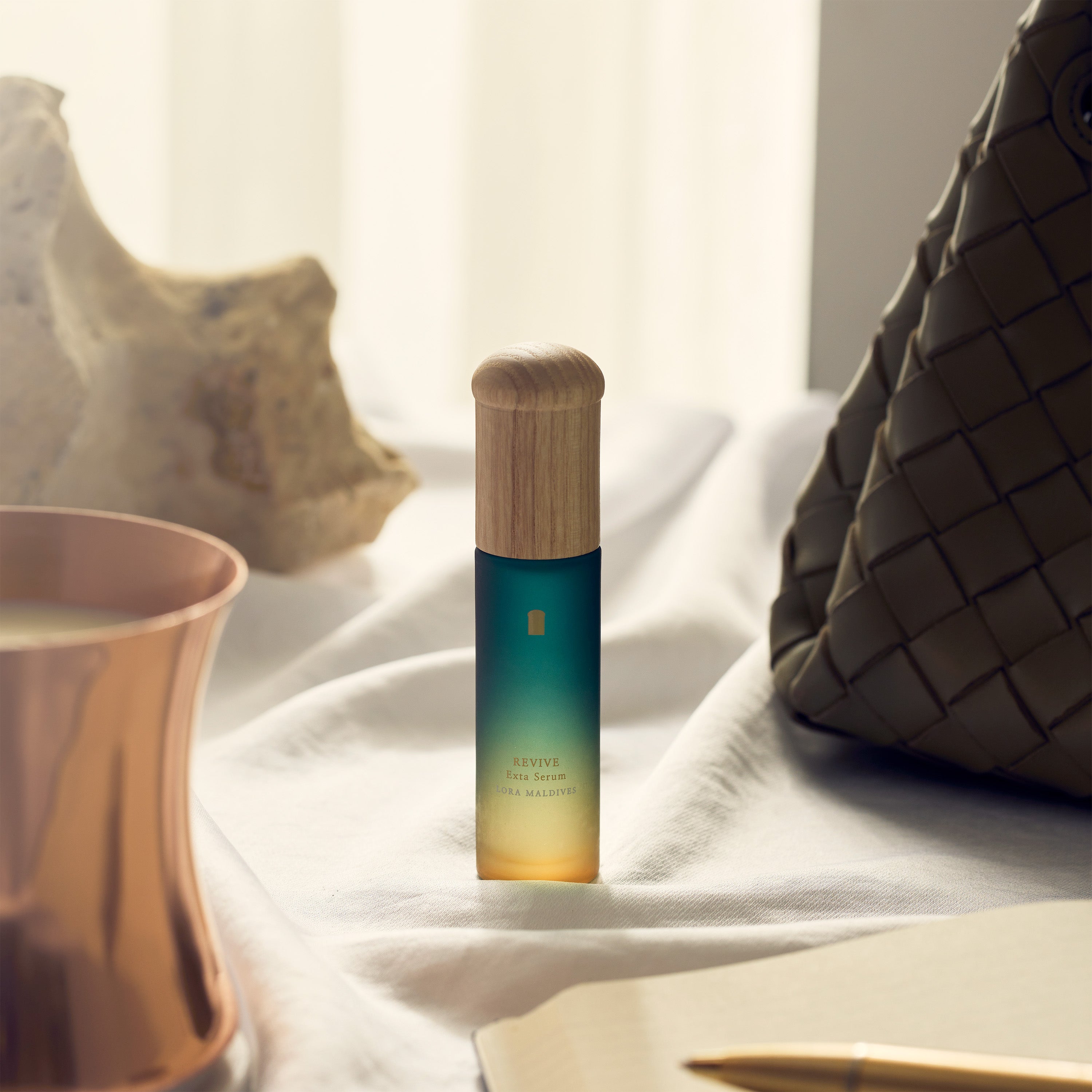 Product on a clean desk setup — Revive Exta Serum displayed beautifully on work desk, aesthetic and premium