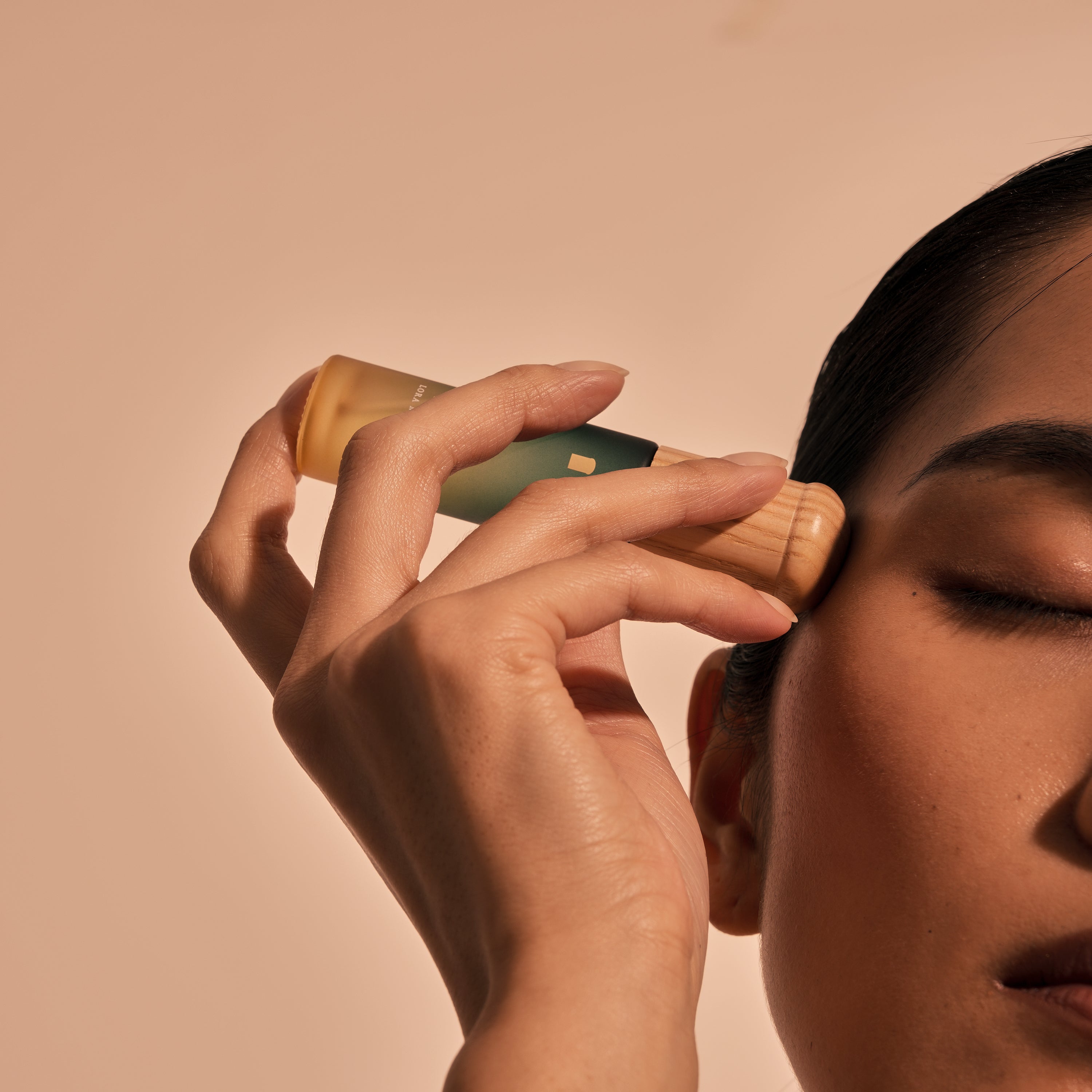 One-handed effortless use — rolling serum onto neck while at desk, no extra effort, mid-work scene