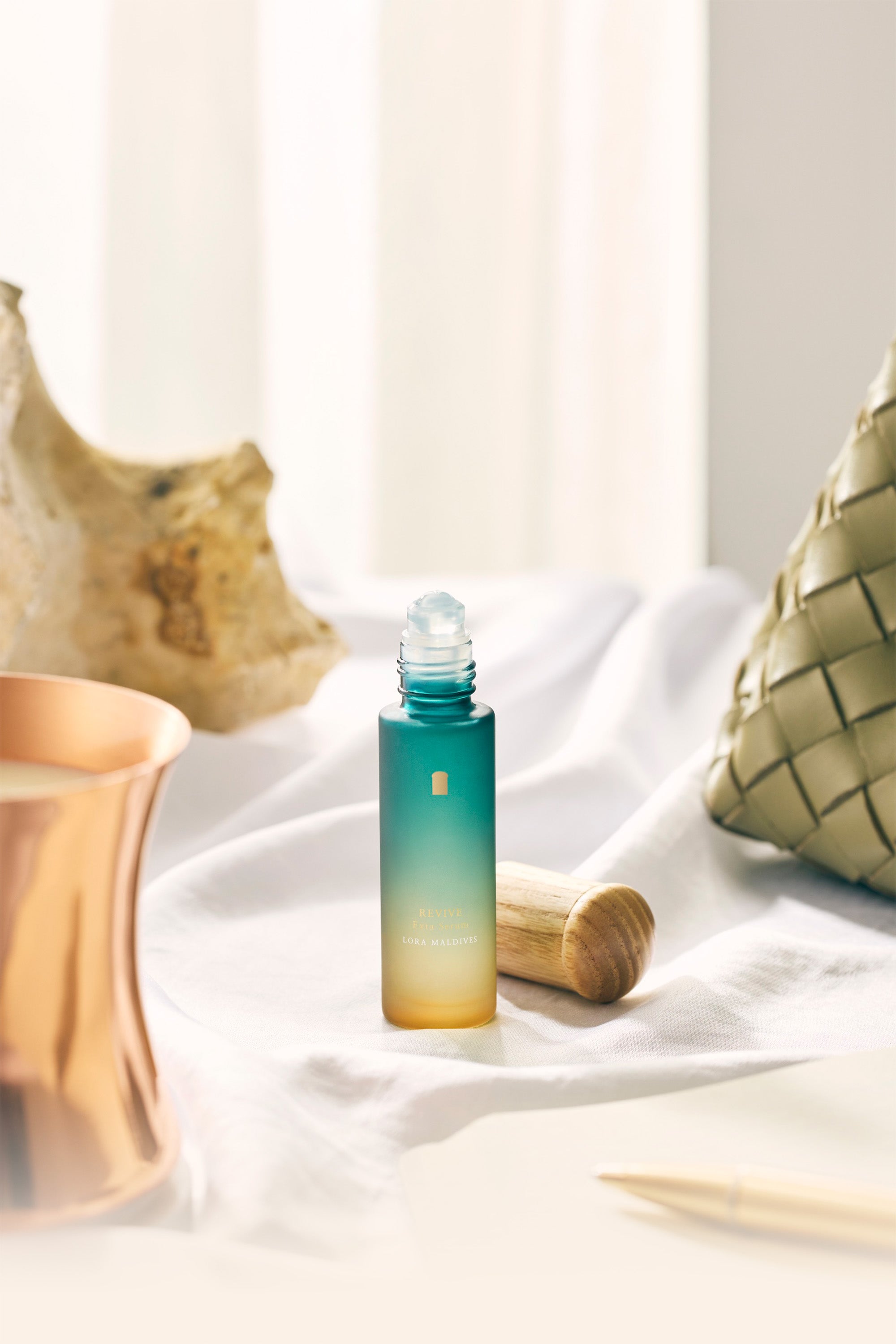 Revive Exta Serum — product hero shot, serum bottle with woodcap, clean and premium on ivory or linen background