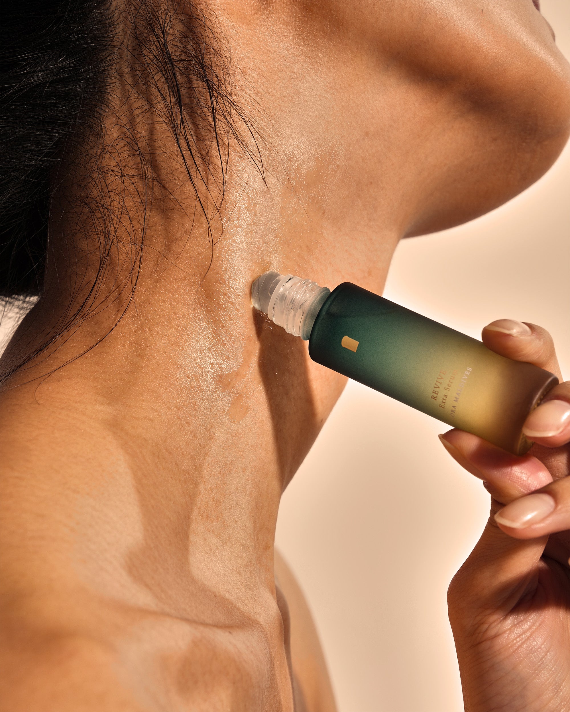 Close-up of rolling the serum onto the back of the neck — cooling serum touching skin, sensual and refreshing